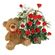 Teddy Bear & Roses. A charming teddy bear and and arrangement of tender red roses with greens in basket.. Minsk